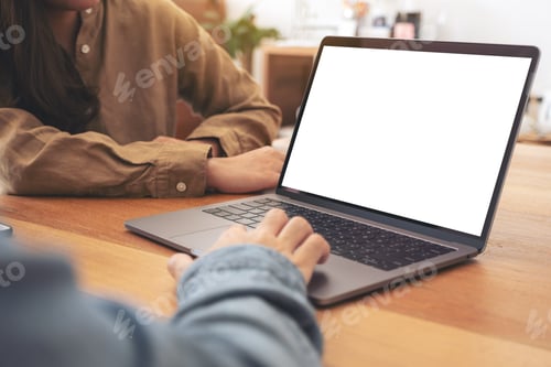Preview: People using and looking at mockup laptop computer on wooden table together