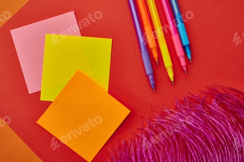 Preview: Pens and notepads closeup, red background