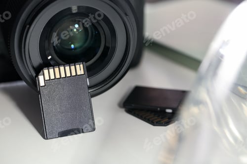 Preview: SD memory cards and photo camera on white table, closeup