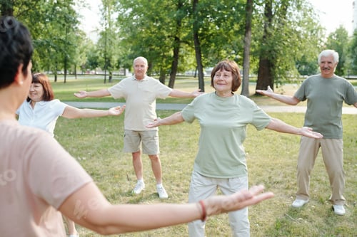 Seniors Exercising Together in a Green Urban Park