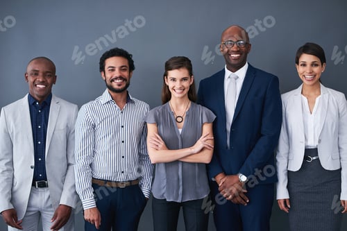 Preview: Studio shot of corporate businesspeople posing against a gray background