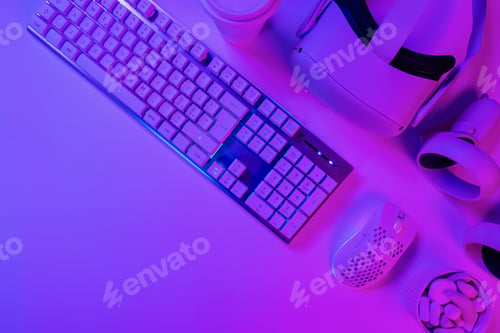 Preview: Keyboard with mouse and headphones on blue desk