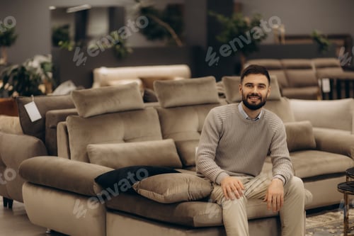 Preview: Man Sitting on a Comfortable Sofa in a Furniture Showroom