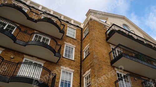 Preview: Exterior of modern yellow brick house. Architectural detail of close-up on windows, balconies. Real