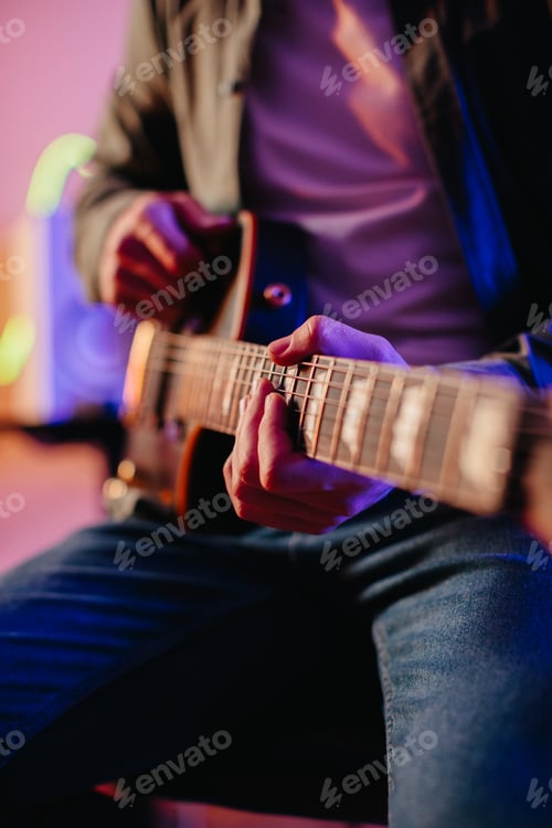 Preview: Guitarist Playing in a Colorful Neon Light Setting