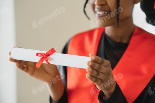 Preview: beautiful young afro american graduate holding diploma