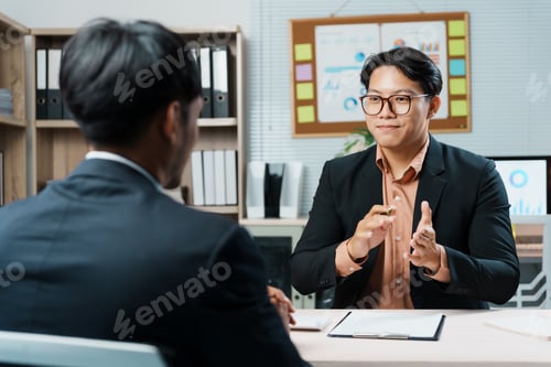 Preview: Asian manager interviewing a job applicant in the office