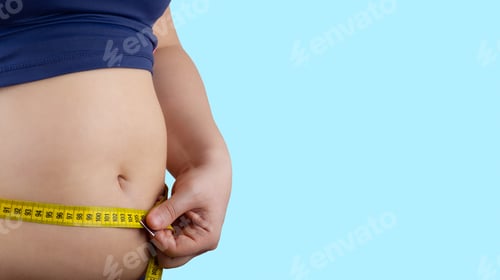 Preview: Overweight woman with measuring tape measuring waist, horizontal, copy space, isolated on blue