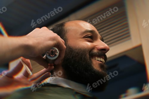 Preview: Smiling man visiting barbershop