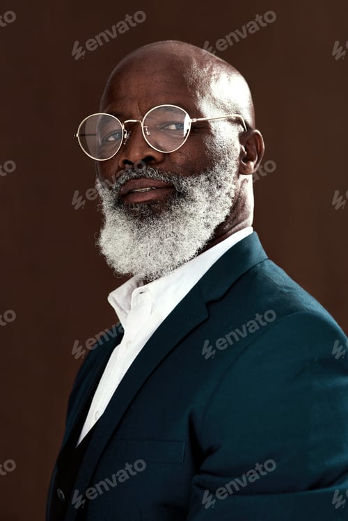 Preview: Studio shot of a mature businessman posing against a brown background