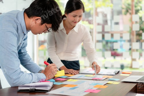 Preview: Business executive team brainstorm and takes notes on keyword about a new business project