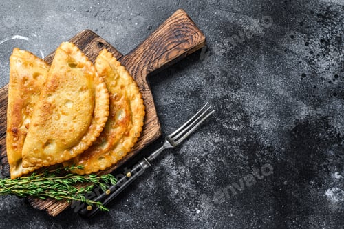 Preview: Fried in oil chebureks with meat and herbs, traditional Caucasian cuisine.
