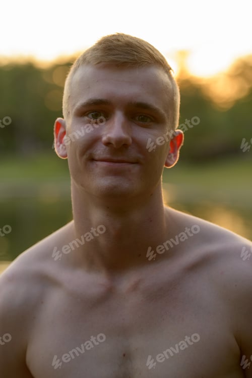 Preview: Young man with blond hair shirtless at the park outdoors