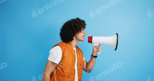 Preview: Man, profile and protest with megaphone in studio for strike, announcement or message on a blue bac