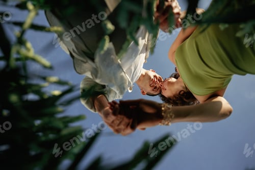 Preview: View from below of couple that is standing in the agricultural field