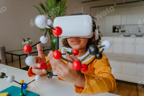 Preview: Cute girl using VR glasses holding molecular model learning chemistry science.