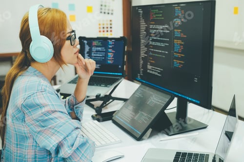 Preview: Young woman covering her face with the stress of work coding and programming software.