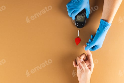 Preview: Hands of gloved doctor with glucometer taking blood sugar reading from caucasian woman, copy space