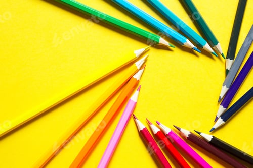 Preview: Set of colorful pencils on a yellow background is laid out in a circle in the shape