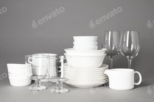 Preview: Set of clean tableware on grey background. Washing dishes