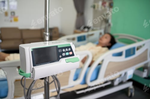 Preview: Middle-aged Asian female patient recovering from illness in hospital room, health care concept.