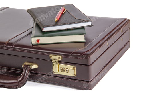 Preview: Modern leather suitcase with notebooks and pen, isolated on white background