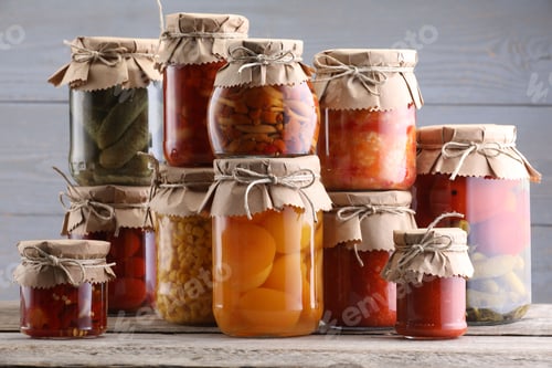 Preview: Many jars with different pickled products on wooden table