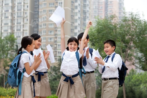 Preview: Cheerful schoolchildren in uniform celebrating for their test results