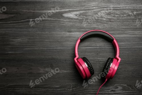 Preview: Stylish headphones on wooden background, top view. Space for text