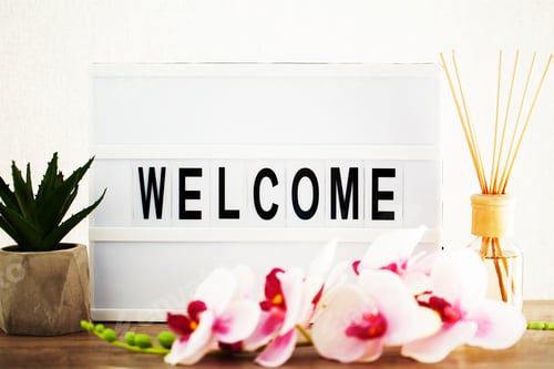 Preview: Led letter board with welcome word on table.