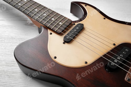Preview: Modern electric guitar on wooden background. Musical instrument