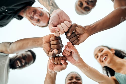 Preview: Shot of a group of friends fist bumping one another before a workout