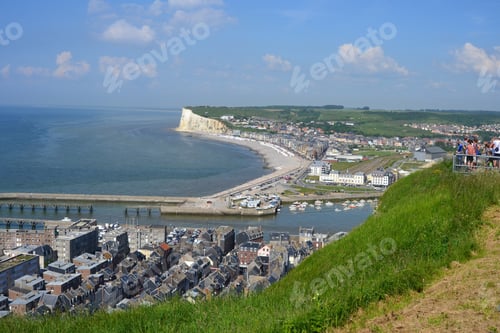 Preview: Aerial shot of a city in a bay area with blue ocean and green land in the background