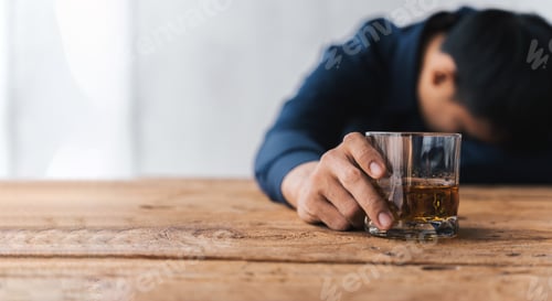 Preview: drunk asian man hold whisky glass addicted alcohol need therapy.