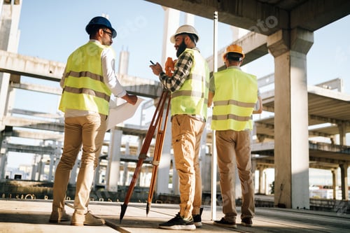 Preview: Team of construction engineers working on building site