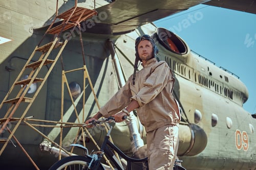 Preview: Mechanic in uniform and flying near the large military helicopter while in an open-air museum.