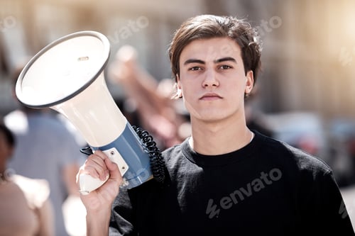 Preview: We will not be ignored. Shot of a young man holding a megaphone during a protest rally.