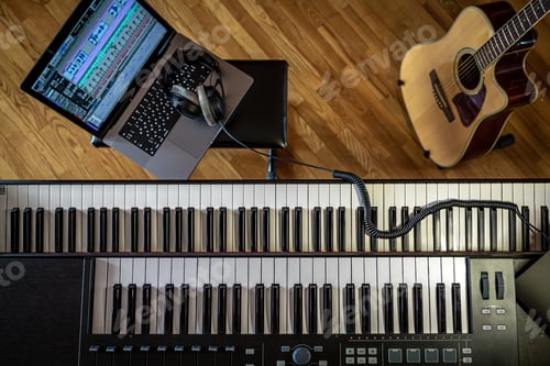 Preview: Piano keys, top view, musician's workplace with laptop.