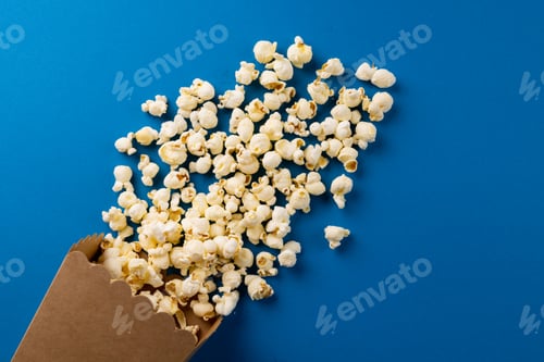 Preview: Image of pop corn scattered on blue surface