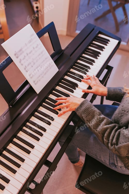 Preview: Close-up of girl hands on the piano