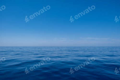 Preview: Sea water surface calm with small ripples, deep blue color and blue sky background,