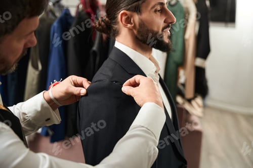 Preview: Experienced clothier altering suit of male client