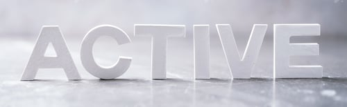 Preview: Word ACTIVE made with cement letters on grey marble background. Copy space. Business concept
