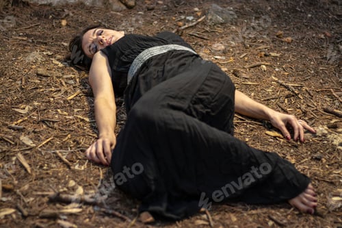 Preview: Young female in a black dress lying unconscious in a forest