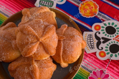 Preview: Pan de muerto with sugar skull figures on colorful serape. Day of the Dead celebration.