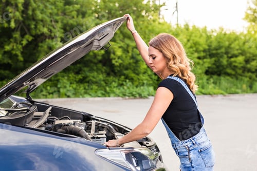 Preview: Woman opens car hood and tries to repair the broken car on the road