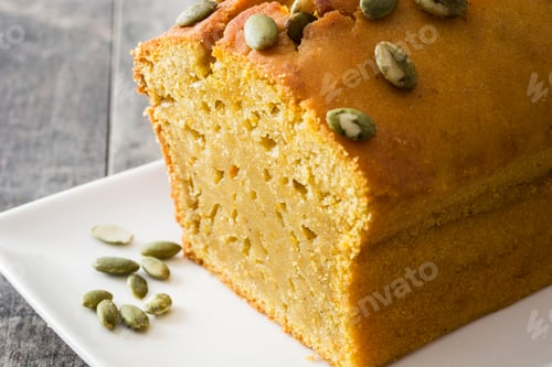 Preview: Sliced pumpkin bread decorated with pumpkin seeds on white plate
