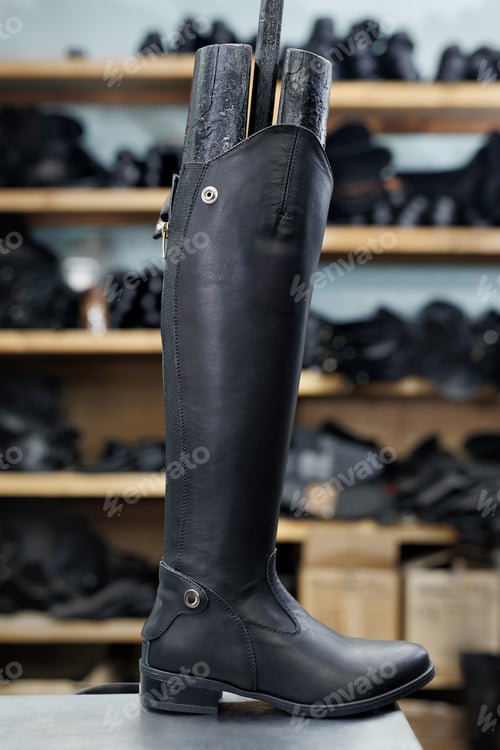 Preview: Leather riding boots in a shoe factory in a warehouse.