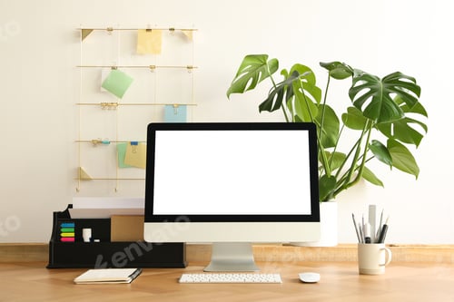 Preview: Comfortable workplace with modern computer near on table near white wall. Space for design