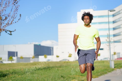Preview: Black athletic man running in an urban park